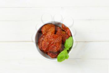 bowl of dried and pickled tomatoes on white background