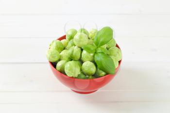 bowl of raw Brussels sprouts on white background