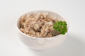 bowl of fish spread on white background
