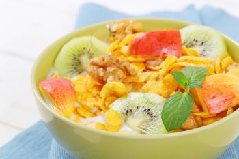 bowl of corn flakes with milk and fresh fruit - close up