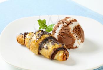 chocolate chip croissant with scoop of ice cream on white plate