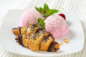 chocolate chip croissants with two scoops of pink ice cream on white plate