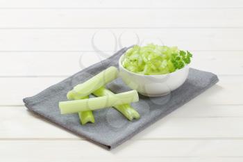 bowl of chopped celery stems on grey place mat