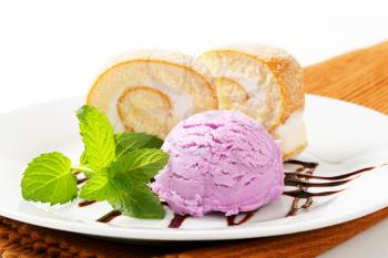 Slices of sponge cake roll with blueberry ice cream