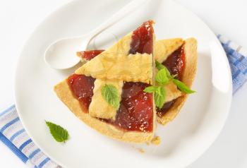 slices of strawberry jam tart  on white plate