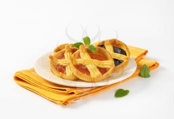 apricot and plum jam tarts on white plate