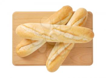 three french baguettes on wooden cutting board