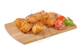 fried corn flake crusted chicken meat on wooden cutting board