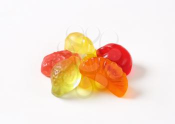 Fruit-shaped gummy candy on white background