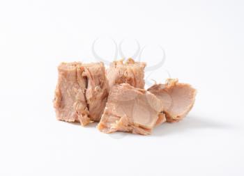 pieces of canned tuna on white background
