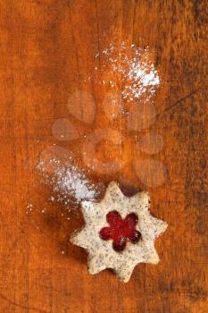 shortbread cookie with jam filling on wooden background