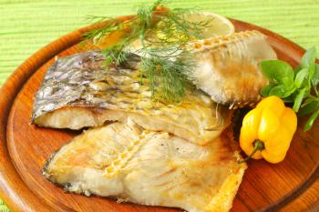 Oven baked carp fillets on cutting board