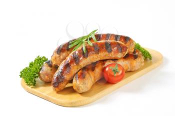 Grilled German sausages on cutting board