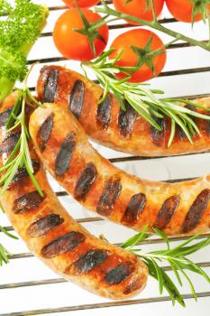 Grilled sausages on barbecue grid