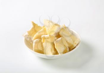 Pieces of French white rind cheese in a bowl