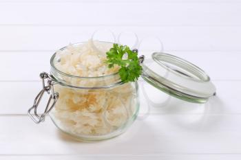 jar of cooked rice pasta fusilli on white wooden background