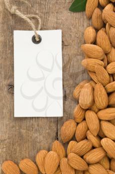 nuts almond and tag price label on wood background