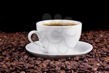 cup of coffee and beans on black background