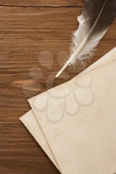 ink pen with envelope on vintage wood background texture