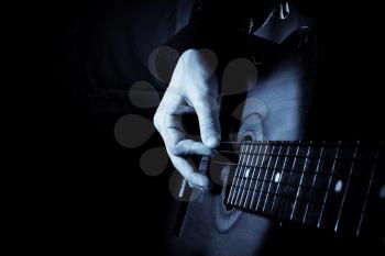 blue guitar at black background