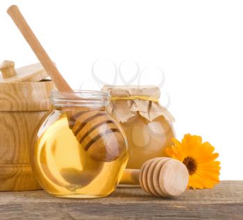 honey in glass and wood pot isolated on white background