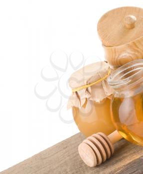 jar full of honey and stick isolated on white background