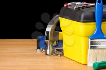 toolbox and construction tools isolated on black background