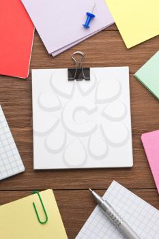 note paper and office accessories on wood background