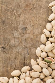 pistachios nuts on wood background