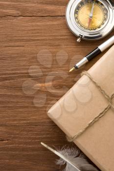 parcel wrapped with brown paper on wood background