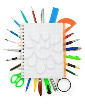 school supplies and checked notebook isolated on white background