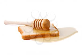bread and honey on white