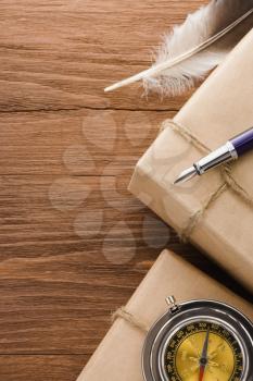 parcel wrapped with brown paper tied with rope on wood background
