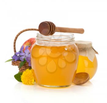 glass jar full of honey isolated on white background