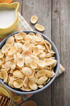 bowl of corn flakes  on wooden background