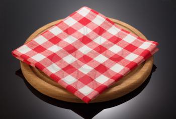 napkin cloth and cutting board on black background