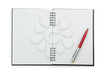pen on checked notebook isolated at white background