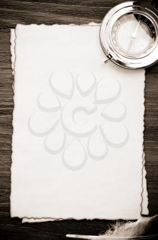 ink feather and compass on parchment background texture