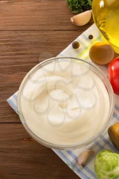 mayonnaise sauce in bowl on wooden background