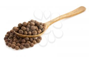 allspice in spoon isolated on white background