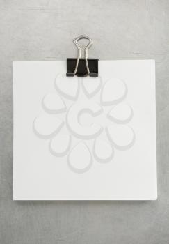 note paper and clip at metal background texture