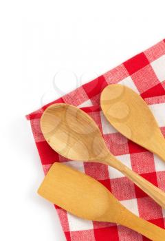 wooden kitchen tools at cloth napkins isolated on white background
