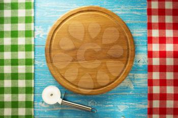 pizza cutting board at wooden background