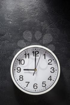 wall clock at black background texture