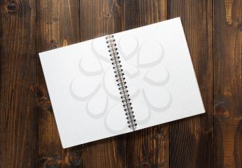 checked notebook on brown wooden background