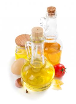 bottle of oil isolated and spices at white background
