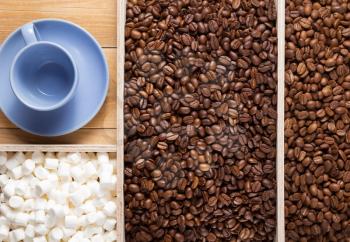 coffee beans in wooden plank box background, top view