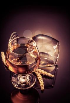 cognac glass on black glossy background