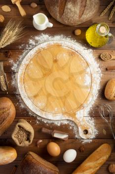 wheat flour and bakery ingredients on wooden table background