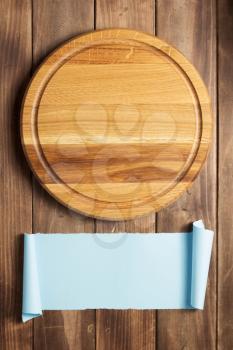 pizza cutting board at rustic wooden plank board background